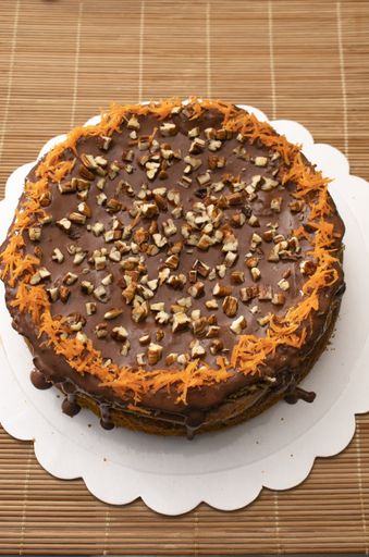 A top view of a delicious chocolate cake sprinkled with nuts
