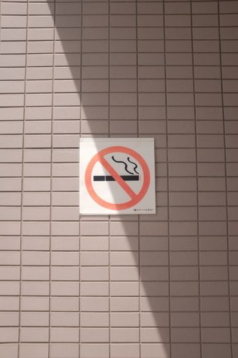 A vertical shot of a "no smoking" sign on the wall