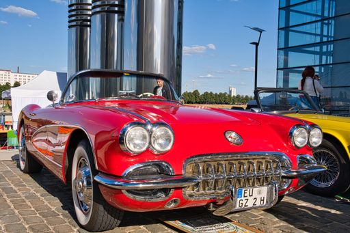 red chevrolet corvette convertible classic c1 from the sixties at the classic car show in cologne, diagonal view from the front