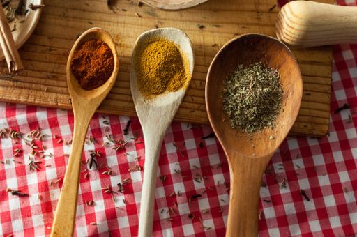 A shot of spices in wooden spoons