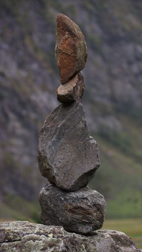 A vertical closeup of a stone cairn in Salzburg, Austria
