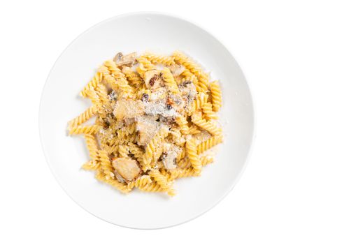 A top view of a white bowl of cooked Fusilli pasta with cheese and meat isolated on a white background