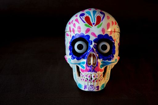 A closeup shot of a Mexican-colored skull on the black background