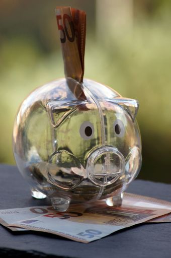 A closeup shot of a piggy bank with Euro banknotes - financial savings concept