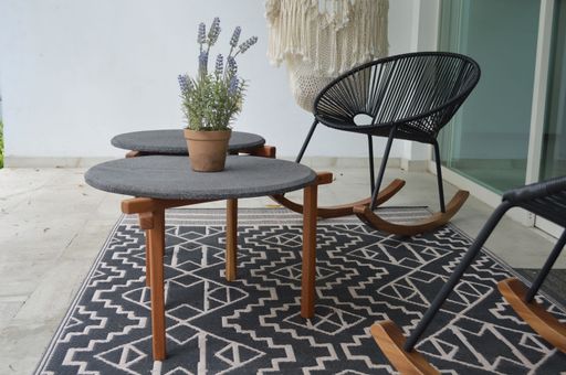 An outdoor terrace with outdoor coffee tables and chairs