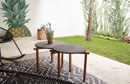 An outdoor terrace with outdoor coffee tables and chairs