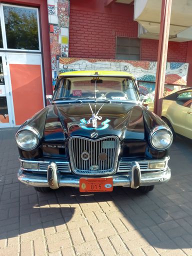 Old Siam Di Tella Riley 1500 sedan 1959 - 1967 in the street. Traditional black and yellow taxi cab in Buenos Aires. Front view. Classic car show.