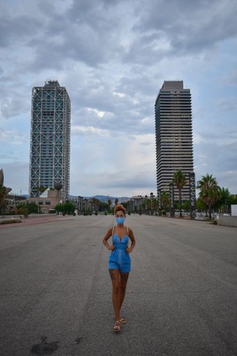 A young female in a protective face mask posing in the city