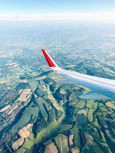 An aerial shot of an airplane tail with an incredible landscape view
