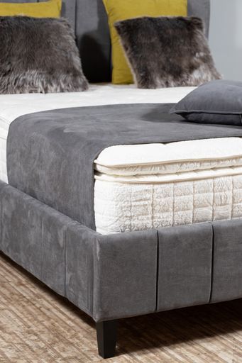 A vertical closeup shot of pillows on a bed