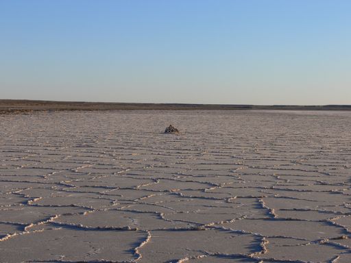 A scenic view of a dry landscape isolated on a blue sky background
