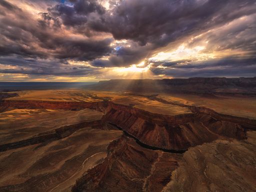 A breathtaking aerial view of the Grand Canyon and Colorado River at sunset