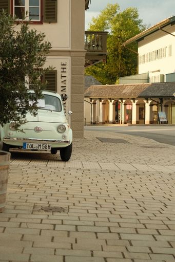 A vertical shot of Pastel Fiat 500 classic car in Gmund am Tegernsee, Bavaria, Germany