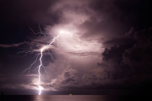 A scenic view of beautiful lightning over the sea in Darwin