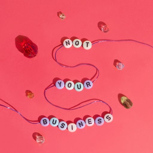 A closeup shot of letter beads forming Not your business expression