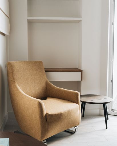 A vertical shot of a pleasant interior with a couch and a small wooden table