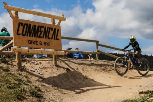 The sign of the bike park "Commencal" with a biker next to it in winterberg, germany.