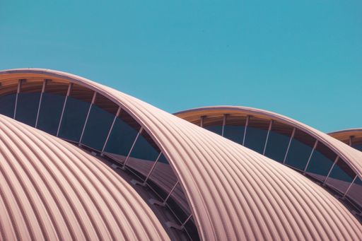 A closeup shot of creative, roundish roofs under the blue sky