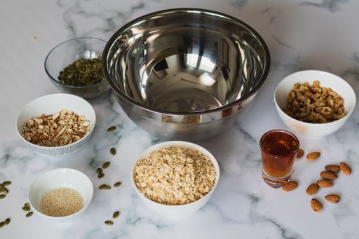 A closeup shot of bowls with healthy ingredients for oatmeal cookies on a kitchen table