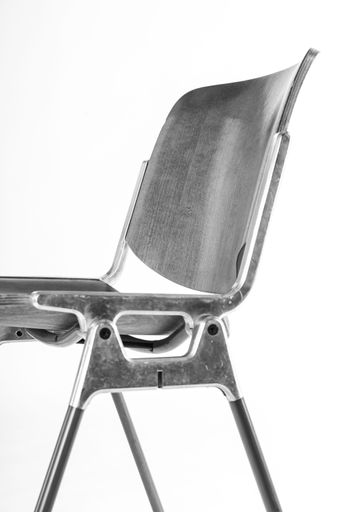 A vertical shot of a black corporate chair isolated on a white background