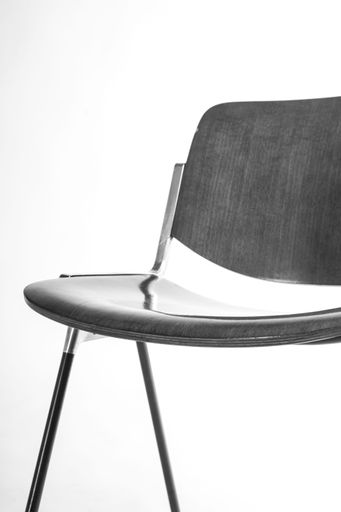 A vertical shot of a black corporate chair isolated on a white background