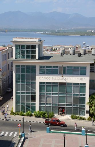 Offices of the Cuban National Bank in Parque Cespedes, in the old quarter of Santiago de Cuba, Cuba - from high viewpoint, looking down on subject.