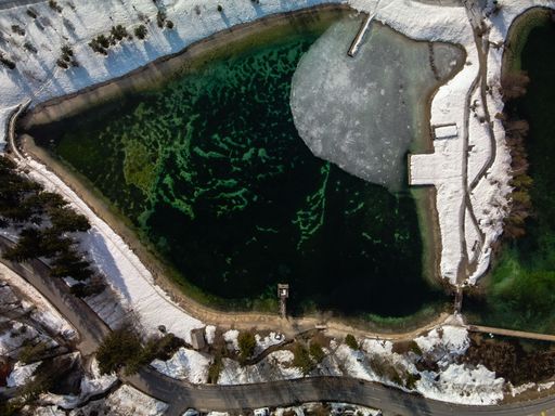 bird's-eye view of Jezero Jasna. Icy man-made lake in Slovenia. Snowy lakeside