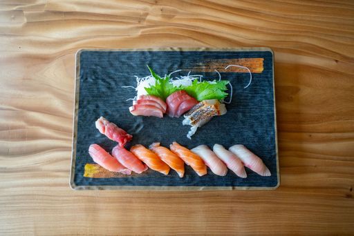 A large platter of sushi with many different pieces at a Japanese restaurant