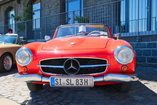 Mercedes 190 SL cabrio, roadster in red from the fifties at the oldtimer show in Cologne, front view