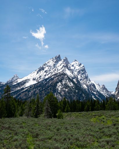 a snowy mountain top during a bright sunny day.