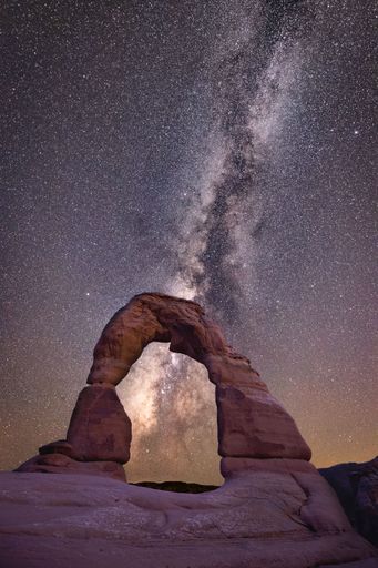 A beautiful scenery of Delicate Arch with the Milky Way galaxy in the background