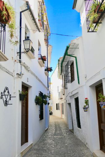 A vertical shot of the Spanish village with urban white buildings