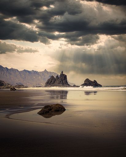 A beautiful shot of sun rays falling on sea waters from gloomy clouds