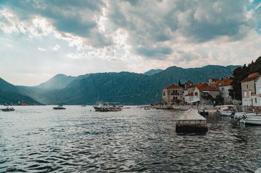 A beautiful shot of boats sailing in the sea at village near Kotor, Montenegro on a cloudy day