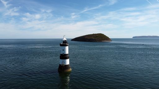 An aerial view of the famous Penmon Lighthouse on a sunny day