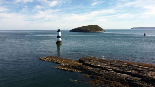 An aerial view of the famous Penmon Lighthouse on a sunny day