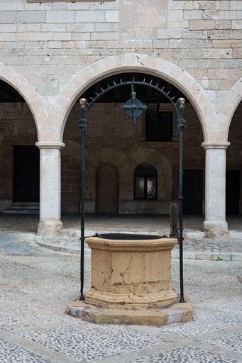 A vertical shot of an old well in an inner courtyard of Bellver castle, Palma, Mallorca island, Spain