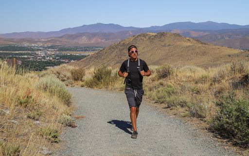 A solo male hiker climbs the trails in the mountains near Carson City.