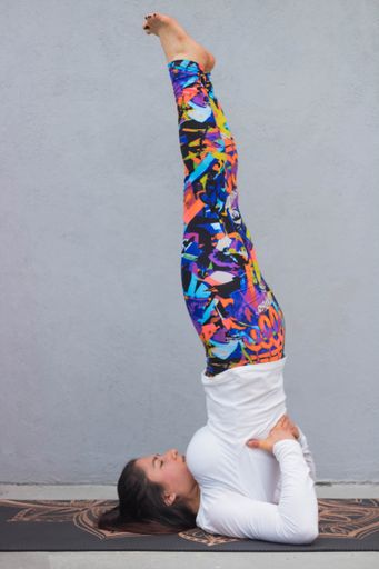 A shallow focus shot of a female doing yoga exercises