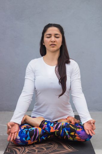 A shallow focus shot of a female doing yoga exercises