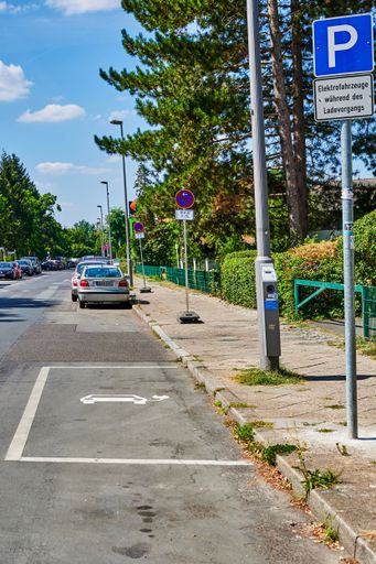 Berlin, Germany - August 11, 2022: View to a public charging station for electric cars at a lantern.