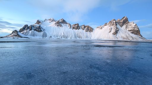 A scenic view of the Stokksnes mountain covered by snow during the winter in Iceland