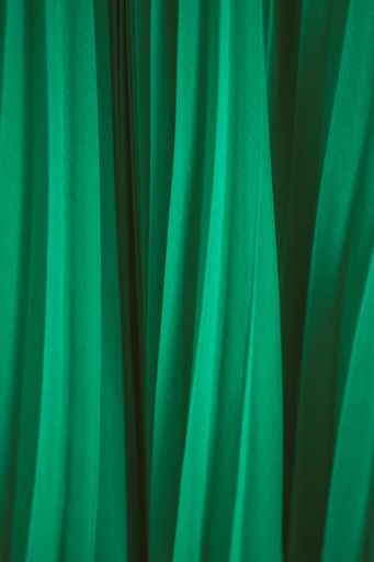 A vertical of green wool serge drapes