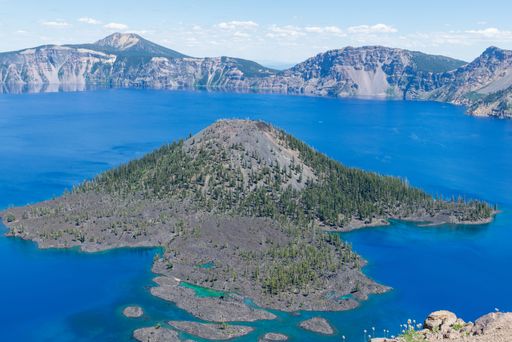 A horizontal image of an above view on Crater lake and its island in National Park in Oregon