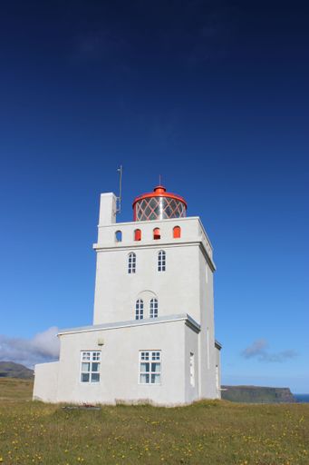 A vertical shot of Dyrholaey Lighthouse located on the central south coast of Iceland