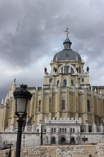 The Cathedral of Saint Mary the Royal of La Almudena under gray sky in Madrid.. Vertical shot