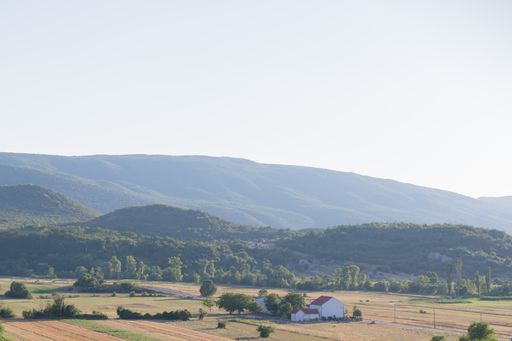 A beautiful scenery of a green mountainous landscape under a cloudy sky