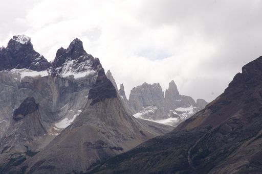 A low angle shot of mountains under the cloudy sky in Torres del Paine National Park, Chile