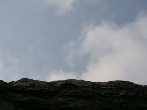 A low angle shot of rock under the beautiful blue sky during daylight