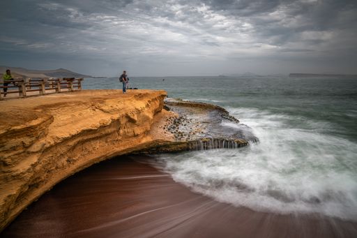 The coast and red sand beach of Paracas National Reserve in Peru